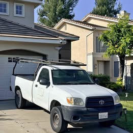 2005 White Toyota Tundra pickup truck with ladder rack